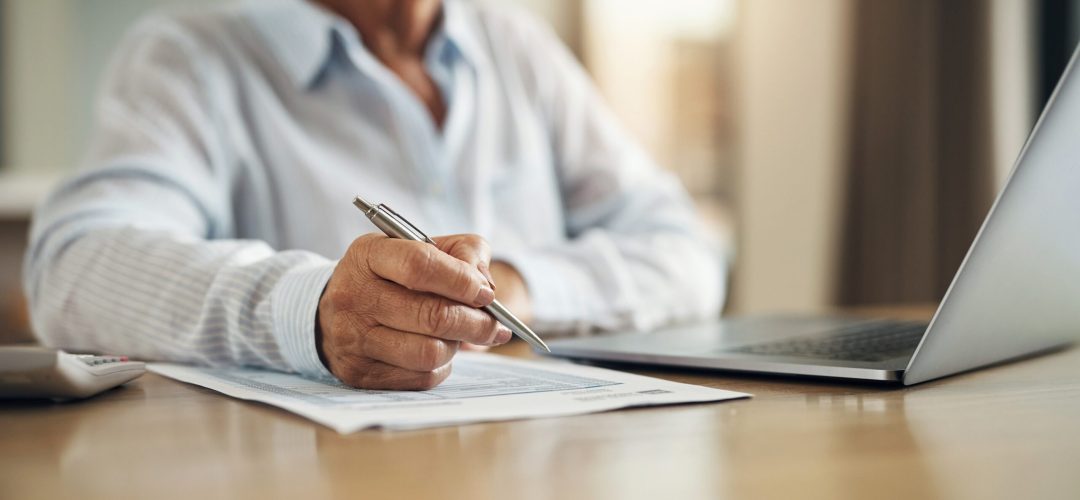 Budget, finance and hands of old woman with paperwork, laptop and pen checking retirement plan, insurance or taxes. Mortgage, income document and online pension savings review, senior person in home